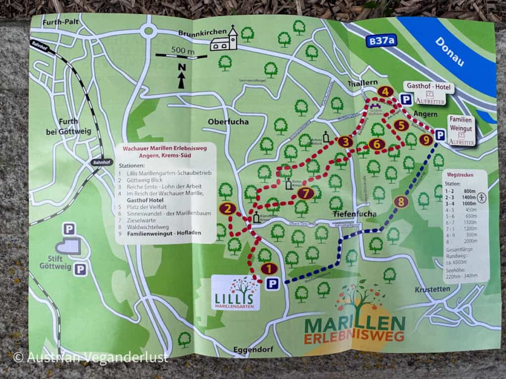 Illustrated map showing "Marillen Erlebnisweg" walking route with numbered stops, nearby towns like "Furth bei Göttweig" and "Angern," paths marked in red and blue, and landmarks including "Donau" river and "Stift Göttweig."